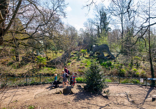 Poznan, Poland – April 07, 2019: People walking on a footpath next to animals in the old zoo