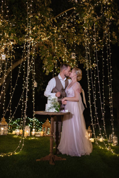 istock newlyweds happily cut and taste the wedding cake 1805633959