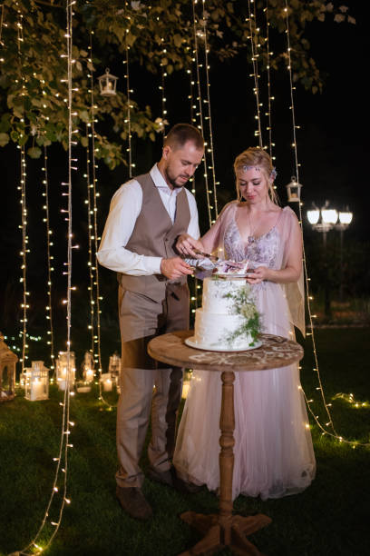 istock newlyweds happily cut and taste the wedding cake 1805639066