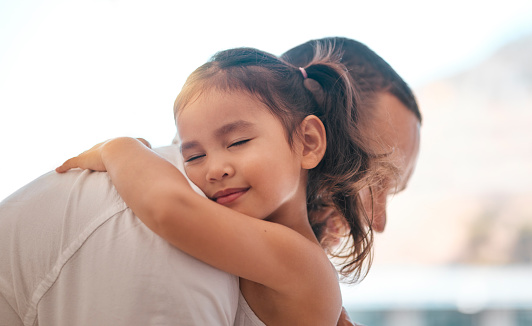 Father, girl or bonding hug in support, love or security in house, family home or adoption center. Smile, happy child or kid embracing man, dad or parent in Indonesian children foster centre in trust