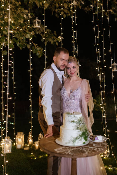 istock newlyweds happily cut and taste the wedding cake 1805642406