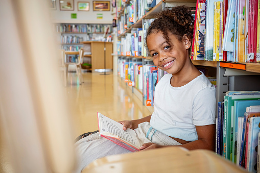 Portrait of a multiracial girl at the public library