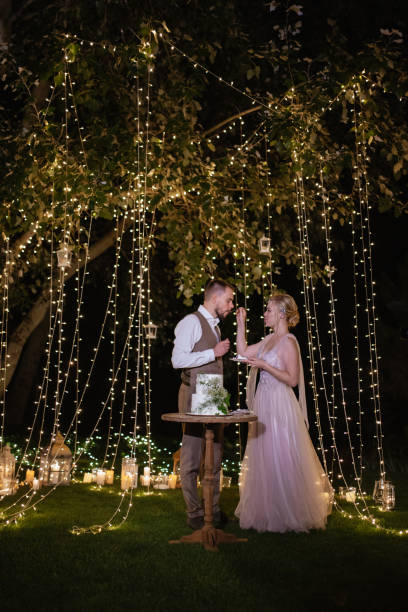 istock newlyweds happily cut and taste the wedding cake 1805652587