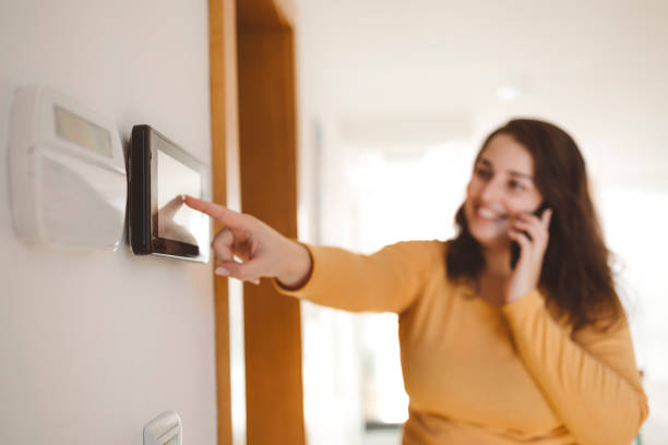istock A woman uses an intercom to open the door 1805654365