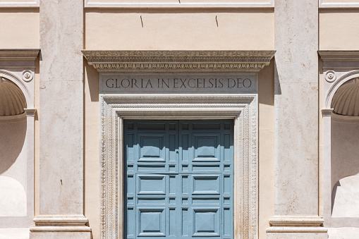 front door of a church in Rome with Gloria in Excelsis Deo; Rome, Italy