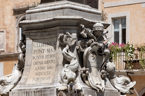 Boy sculptures fishing in water fountain