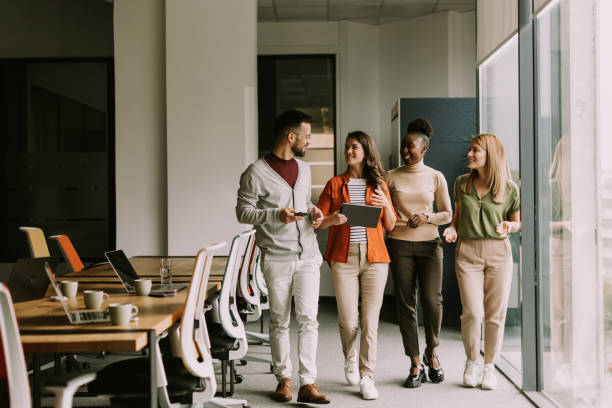 istock Young multiethnic startup team walking in the modern office 1805657772