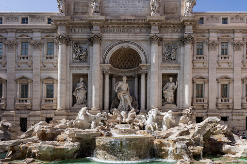 The Trevi Fountain is an 18th-century fountain in the Trevi district in Rome, Italy, designed by Italian architect Nicola Salvi. The image shows the fountain during a hot day in summer.