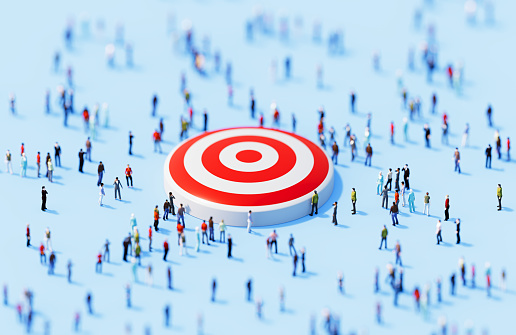 Human crowd surrounding red target object on blue background. Horizontal  composition with copy space.