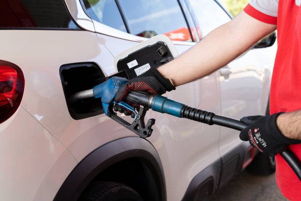 istock Hands of a man, it is a dispenser refueling Ad Blue in a car. 1805661179