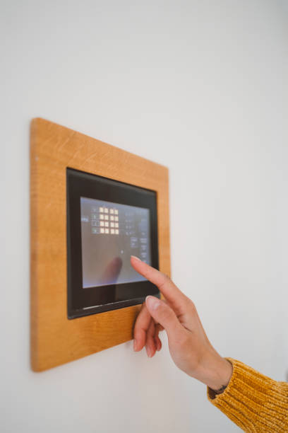 istock A woman uses an intercom to open the door 1805671877