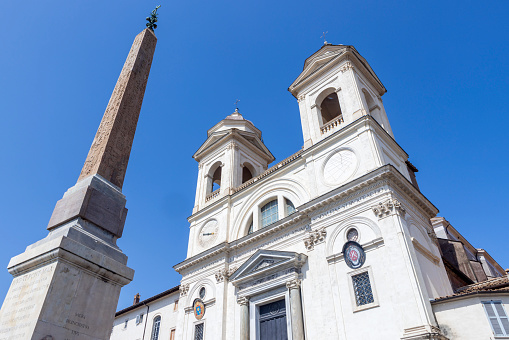 exterior of the Church of Santissima Trinità dei Monti,  a Roman Catholic church in Rome. The church is best known for its position above the Spanish Steps which lead to the famous Piazza di Spagna; Rome, Italy