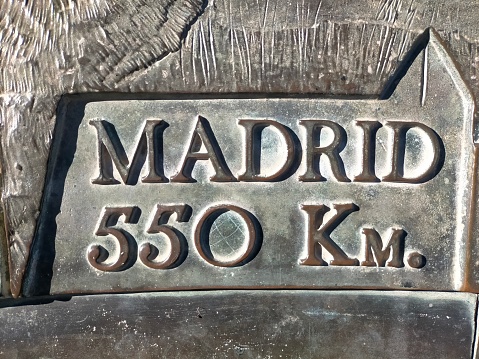 steel plate with the name of Madrid and distance from the province of Barcelona.
