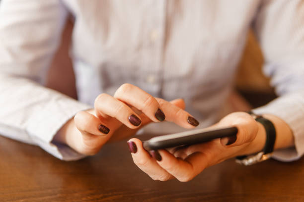istock Mobile phone in female hands. Beautiful women's manicure 1805686036