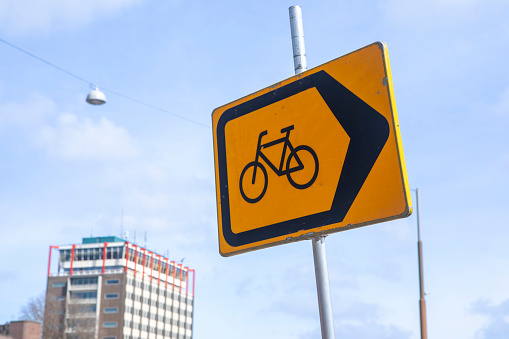 Assorted road signs showing bicycle route and pointing directions to the scenic route.
