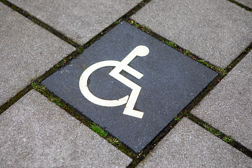 Accessibility sign on a square paving slab