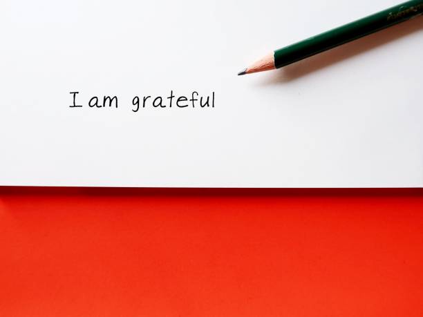 istock Note paper on copy space orange background with handwriteen text I AM GRATEFUL - concept of gratitude , means being thankful or show appreciation for good things or kindness in life 1805709507