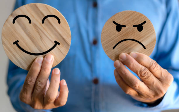 istock Human hand holding wood face different emotion, emotions, happy, relax, satisfaction survey, customer services, positive, good, wellness, health child, hospital, world mental health day 1805710620