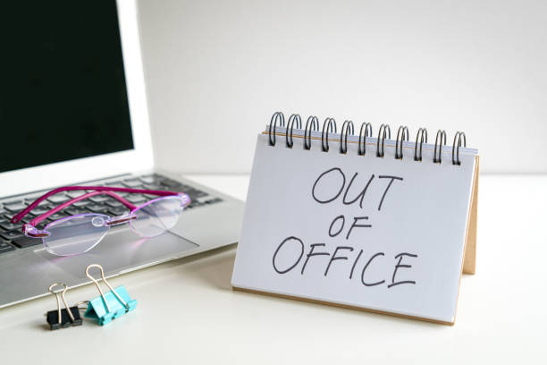 istock Out of office, message next to computer laptop. 1805716805