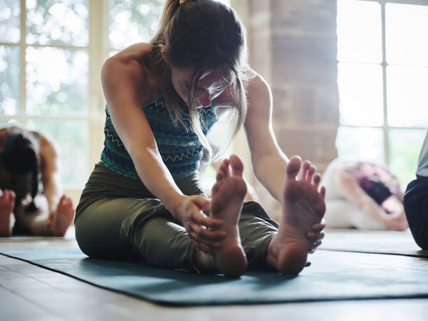 istock Group, woman and stretching for exercise, yoga or legs in gym, class or studio with mindfulness or zen. Pilates, person and workout for wellness, healthy body or balance in fitness center for posture 1805720595