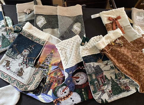 Grandmother shows handmade  Christmas decoration bags  for Christmas Eve