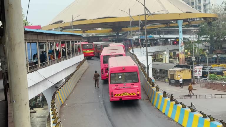 Bus passing through Thane station. Rush hour traffic.