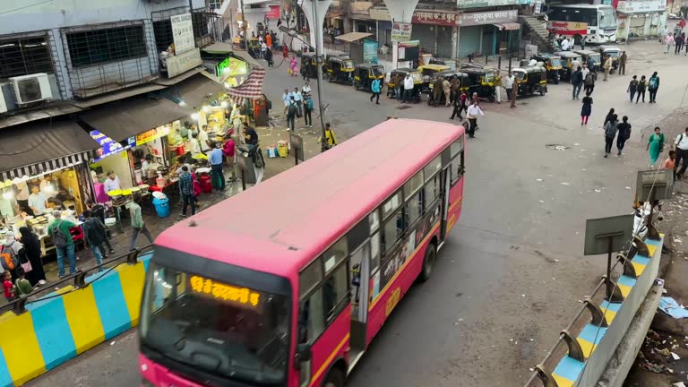 Bus passing through Thane station. Rush hour traffic.