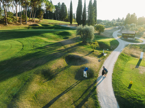 istock Aerial view of a golfer with caddy on the golf course 1805749399