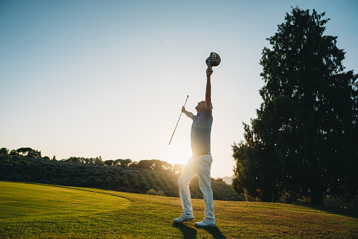 Hole-in-one celebration for a professional golfer. He's celebrating at sunset.