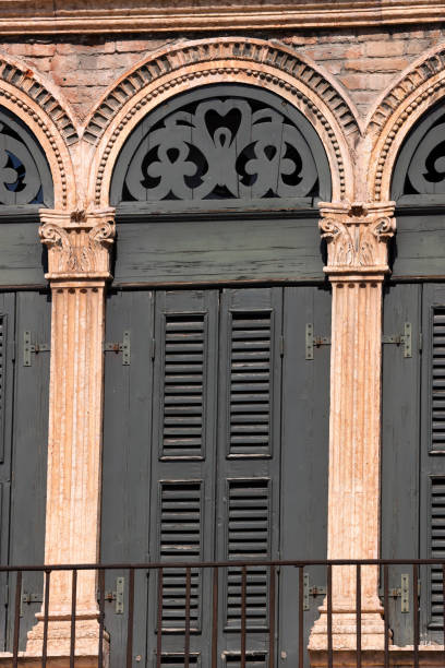 istock ancient window with arch and green shutters 1805764870