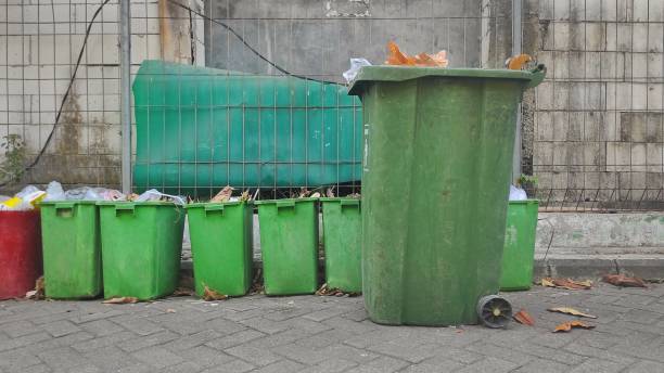 istock Green trash bin in the urban area to keep people throw their trash in it 1805771906