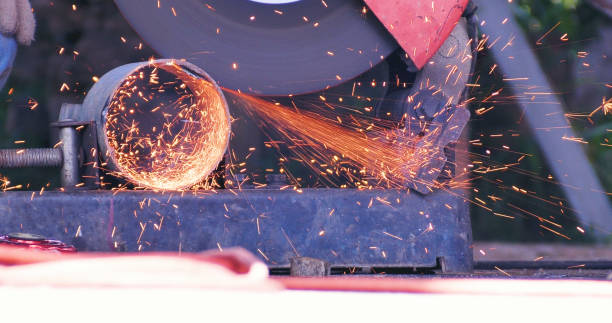 istock Hot flame welding metal work cutting fire iron workshop. Welding machine iron metal sparking. Locksmith using Welding machine cutting metal processing grinder. Close up hands Sparks in metalworking 1805775784