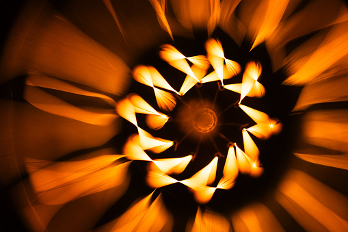 Abstract background with a tungsten lamp spiral glowing in the dark, macro photo with selective soft focus