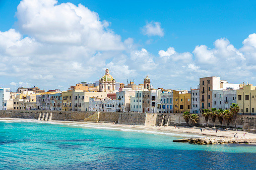 Promenade and beach with people around in the old town of Marsala, Trapani, Sicily, Italy