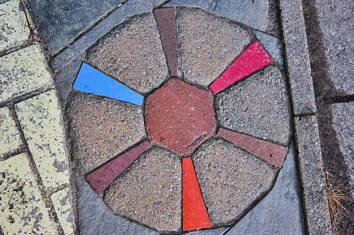 Image of Colorful round sidewalk decoration like spokes of a wheel, abstract art like video game