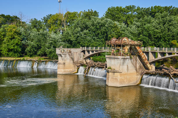istock Logs going over waterfall at Maumee River Dam on sunny summer day with forest tree line Fort Wayne, IN 1805805725