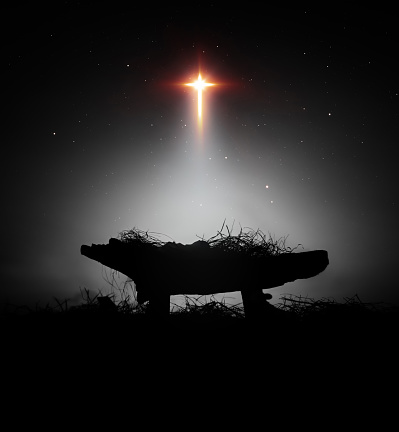 A bright and large star shines brightly, blessing baby Jesus in the manger in the stable, a background that celebrates Christmas and the birth of Jesus and his death on the cross.