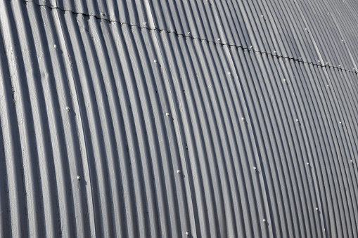 Corrugated galvanized steel panels on the exterior of a building. For background, wallpaper or clipping mask.