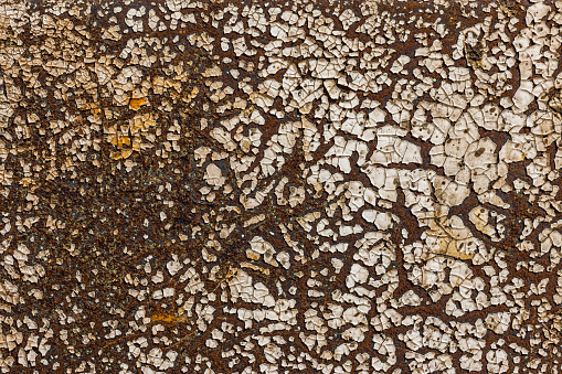 Old dirty rusted grungy flaked and cracked paint on rusted metal for background or text clipping mask.