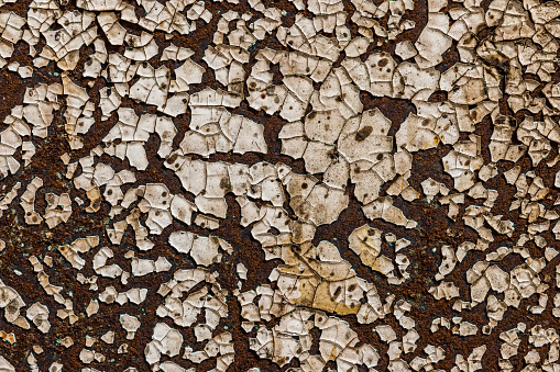 Old dirty rusted grungy flaked and cracked paint on rusted metal for background or text clipping mask.