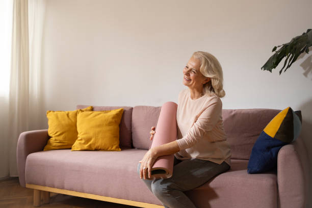 istock Active grandmother posing with her yoga mat 1805831246