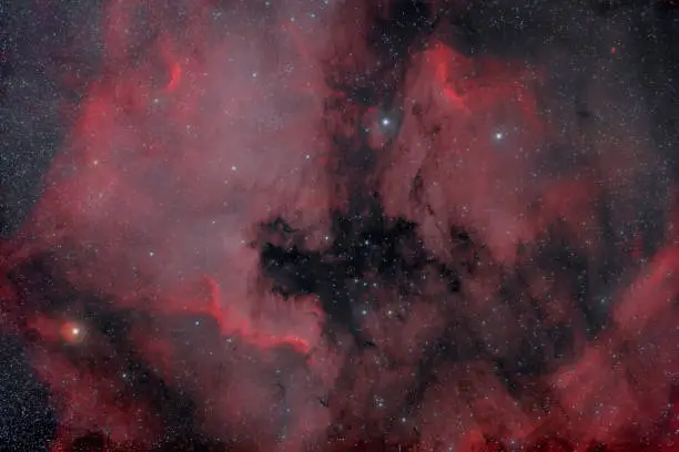 Photograph of space through a telescope. Hydrogen nebula NGC 7000. Space nebula North America.