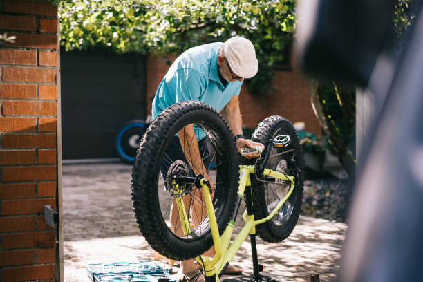 istock Senior man doing maintenance on his fatbike 1805835000