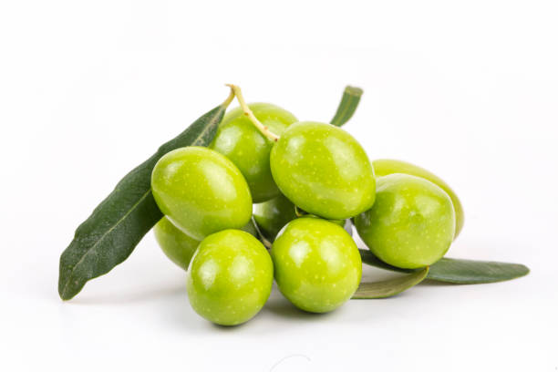 Green fresh olives on the white background