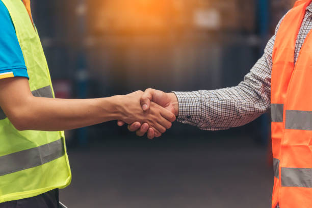 istock Close up Engineer man hands shakehand together Warehouse partnership. Diversity Coworker Men warehouse worker logistics teams handshake. Multiracial Support team greeting person teamwork colleagues 1805848678