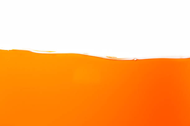 istock Orange juice isolated white background,orange juice texture on white background,Close up bright orange juice texture for health and nature waves 1805850494