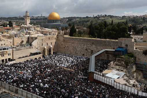 Jewish worshippers crowd into the prayer section below the Western Wall in Jerusalem for the Blessing of the Cohanim or priestly blessing given twice each year to the Jewish people on the holidays of Passover and Sukkot.