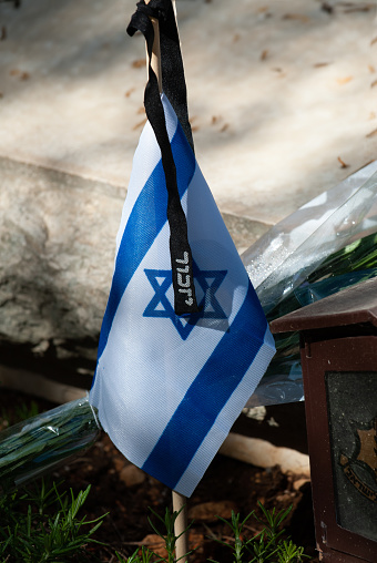 A flag of the State of Israel rests on a grave of a fallen soldier in the Har Herzl military cemetery in Jerusalem on Memorial Day in Israel.