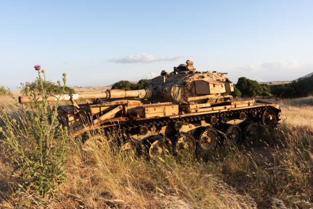 Rusted, abandoned tank from the Yom Kippur war in a meadow on the Golan Heights in northern Israel.