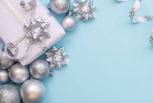 istock Christmas composition white present box with christmas silver tree toys at the blue background. 1805858766